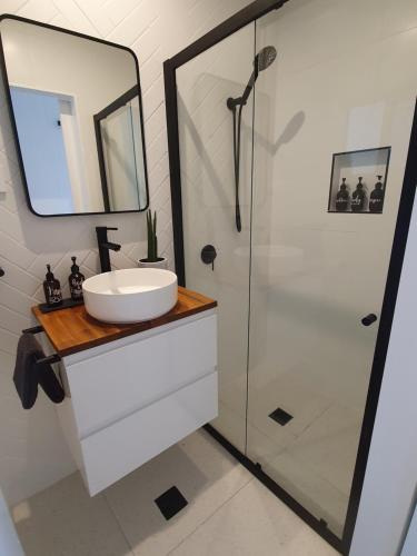 a bathroom with a sink and a shower at Saltwater Apartments in Lake Cathie