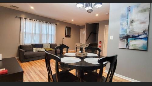 sala de estar con mesa, sillas y sofá en GREAT 2 bedroom Condo,FREE parking,easy commute. en Irvington