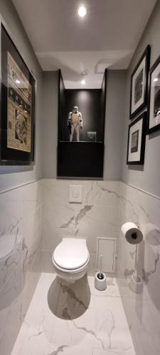 a bathroom with a toilet and a picture of a robot at villa l'Ambroisine in Lure