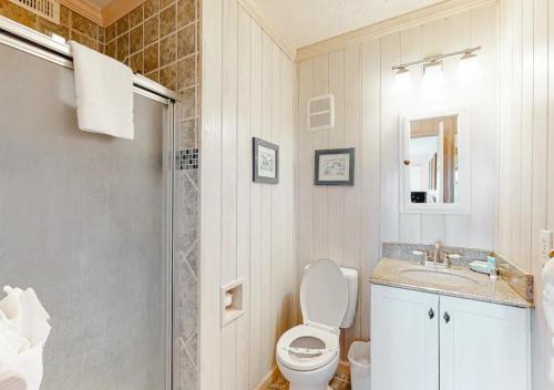 a bathroom with a toilet and a sink and a shower at Dunescape Villas by TO in Atlantic Beach