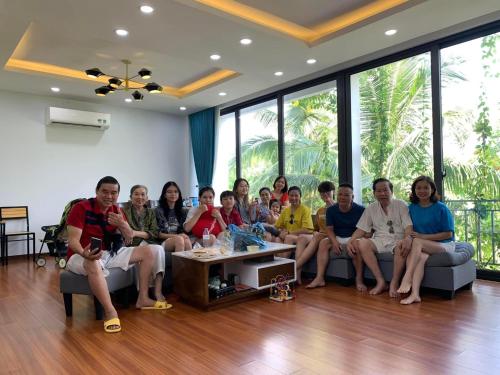 a group of people sitting on a couch in a room at Friendly villa SH Đại Lải 4 phòng ngủ in Phúc Yên