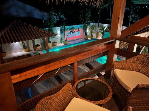 a view of a table and chairs on a balcony at Villa Éden in Alter do Chao