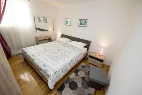 - une petite chambre avec un lit et un miroir dans l'établissement Apartments by the sea Promajna, Makarska - 17160, à Promajna