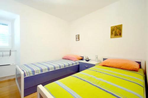 a bedroom with two beds and a window at Apartments by the sea Sumartin, Brac - 17090 in Sumartin