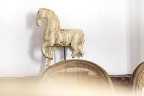 a statue of a horse on top of a shelf at Hotel Boutique Casa del Coliseo in Cartagena de Indias