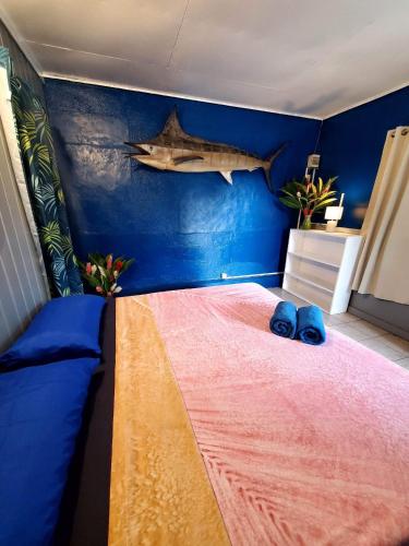 a bedroom with a bed with a shark on the wall at Hiaai in Haapu
