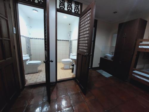 a bathroom with a toilet and a sink at Makabata Guesthouse & Cafe in Manila