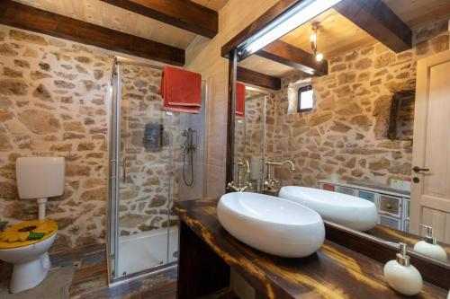 a bathroom with two sinks and a shower at Family friendly house with a swimming pool Bogatic, Krka - 17168 in Oklaj
