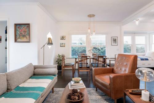a living room with a couch and a table at The Exquisite Venice Beach Bungalow with Garden in Los Angeles