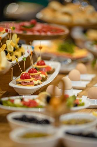 a table full of plates of food with appetizers at Gur Emir Palace boutique hotel in Samarkand