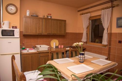 a kitchen with a table and a refrigerator at Apartments with WiFi Daruvar, Bjelovarska - 17093 in Daruvar