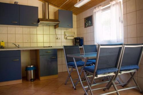 a kitchen with a table and chairs in a kitchen at Apartments and rooms by the sea Molunat, Dubrovnik - 17143 in Gruda