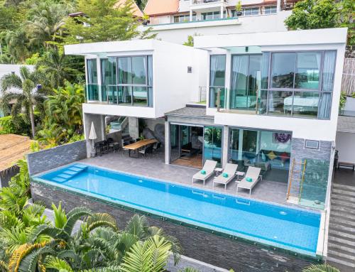 an aerial view of a house with a swimming pool at Baan Saint-Tropez Seaview Villas Kata Beach in Kata Beach