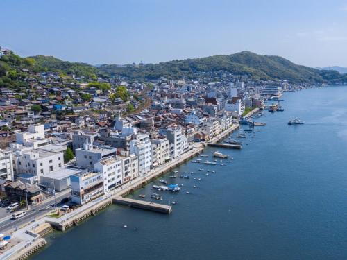 an aerial view of a city with boats in the water at urashima INN - GANGI - in Onomichi