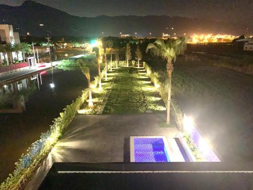 a view of a park at night with palm trees at Jabez Homestay in Yilan City