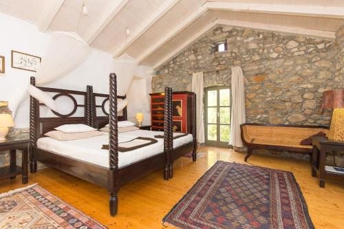 a bedroom with a bed and a stone wall at Family friendly house with a swimming pool Bajcici, Krk - 17293 in Malinska