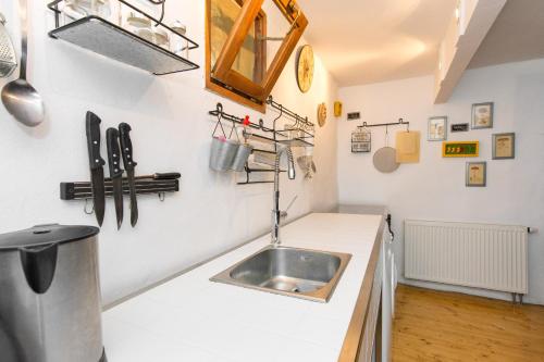 a kitchen with a sink in a white counter at Family friendly house with a swimming pool Bajcici, Krk - 17293 in Malinska