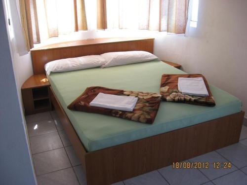a bedroom with a bed with two boxes on it at Apartments by the sea Prizna, Senj - 17309 in Senj