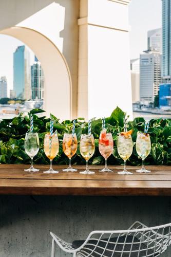 a row of wine glasses sitting on a table at Crystalbrook Vincent in Brisbane
