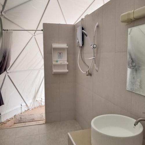 a bathroom with a shower and a sink at Evie Mae Camp in Ban Cha-om