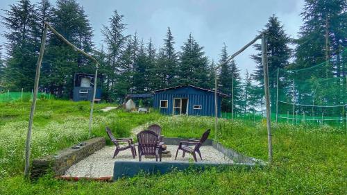 a group of chairs sitting on a patio in a field at HANO Peak in Nāldera