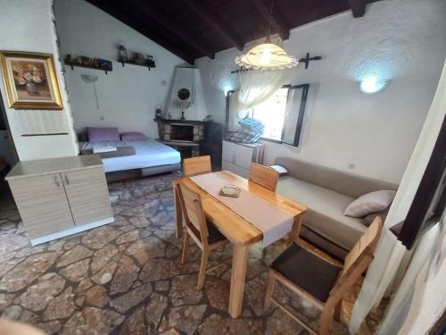 a room with a table and a couch and a bed at Holiday home Ivica - by the sea in Sevid