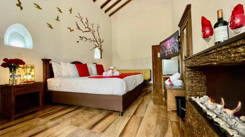 a bedroom with a bed and a fireplace at Hotel Boutique & Spa - VDL Colonial in Villa de Leyva