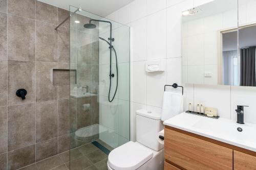 a bathroom with a shower and a toilet and a sink at Hunter Studios - Maitland in Maitland