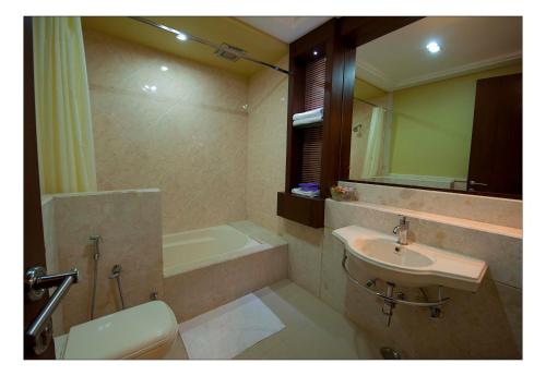 a bathroom with a sink and a bath tub at Lariya Resort in Jodhpur