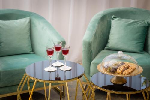 two tables with glasses of wine and a couch at Hotel Corner in Split