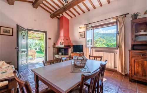 a dining room with a table and a large window at Villamota in Arezzo