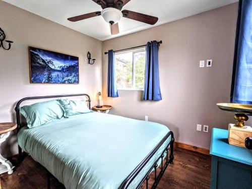 a bedroom with a bed and a ceiling fan at The Luminous Lodge-Remodeled Cabin W/ Valley Views in Santa Ysabel