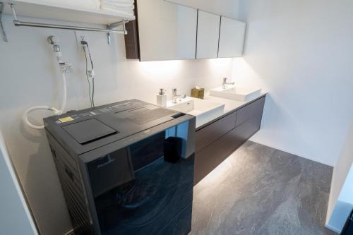 a bathroom with a sink and a shower in it at SETOUCHI SUP RESORT - Ao - in Shodoshima