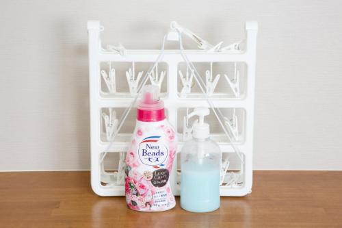 two bottles of milk and detergent sitting on a table at TOMMY CONDOMINIUM WAKASA 202 in Kume
