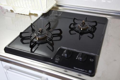 a stove top with two burners on top of it at TOMMY CONDOMINIUM WAKASA 202 in Kume