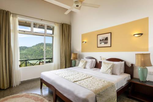 a bedroom with a bed and a large window at Albatross by The Clarks, Kandy in Digana