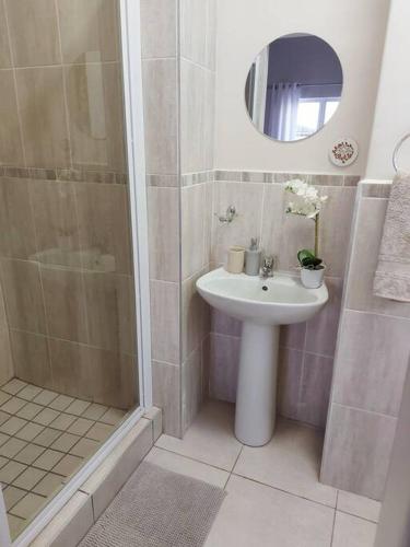 a bathroom with a sink and a shower at Flower Route House in Langebaan
