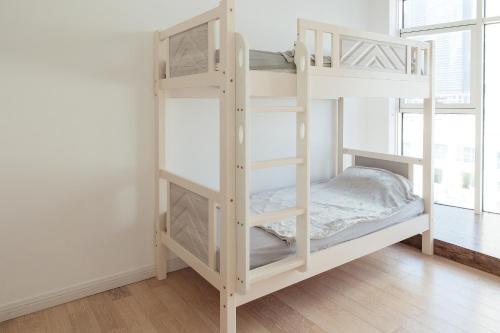 a white bunk bed in a room at Dulive in Dubai