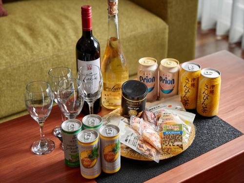 a table with a bunch of bottles and glasses of wine at THE GRAND HOTEL GINOWAN in Ginowan