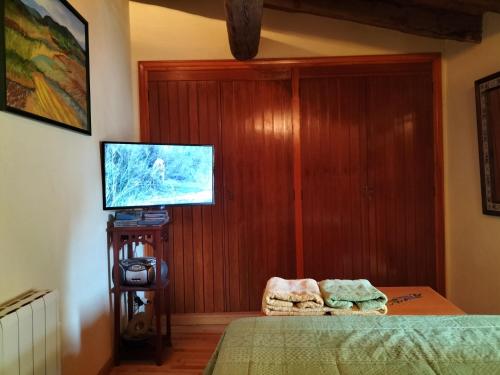 a bedroom with a bed and a flat screen tv at CASA BONITA in Morella