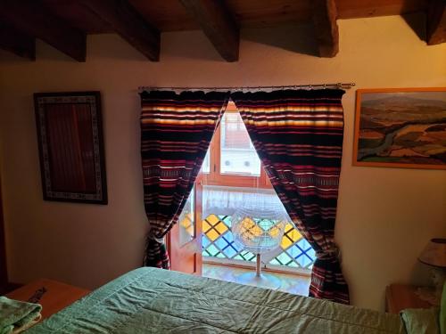 a bedroom with a bed and a window with curtains at CASA BONITA in Morella