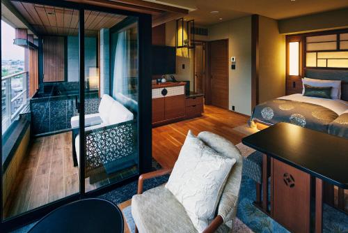 a hotel room with a bed and a bedroom with a view at Sora Niwa Terrace Kyoto Bettei in Kyoto