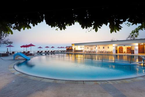 a large swimming pool in front of a hotel at Chom View Hotel, Hua Hin in Hua Hin