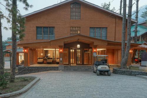 a house with a car parked in front of it at Radisson Golf Resort Pahalgam in Pahalgām