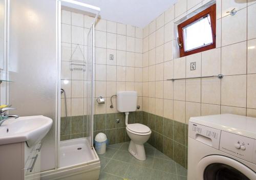 a bathroom with a toilet and a sink and a shower at Apartment Drage 17392a in Pakoštane