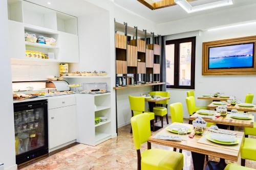 a dining room with tables and yellow chairs at B&B Vanity in Tropea