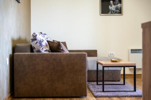 a living room with a couch and a table at Monix Palace Zlatibor in Zlatibor