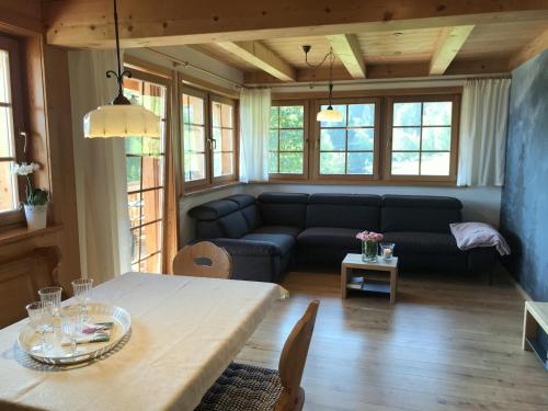 a living room with a couch and a table at Urbanshof Ferienwohnungen in Hinterzarten
