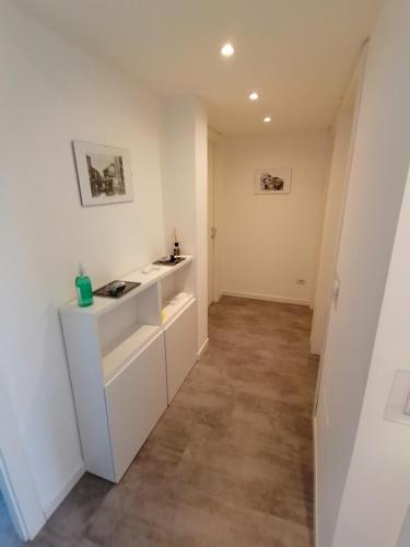 a kitchen with white cabinets and a tile floor at B&B Giolì in Milan
