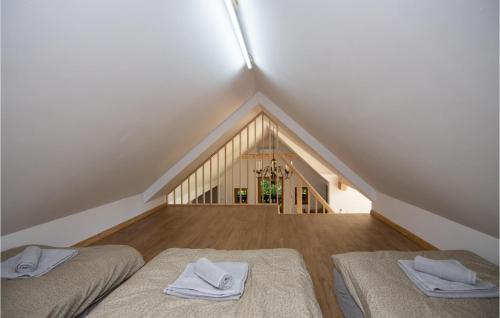 two beds in a room with a attic at 4 Bedroom Amazing Home In Vrhnika in Vrhnika